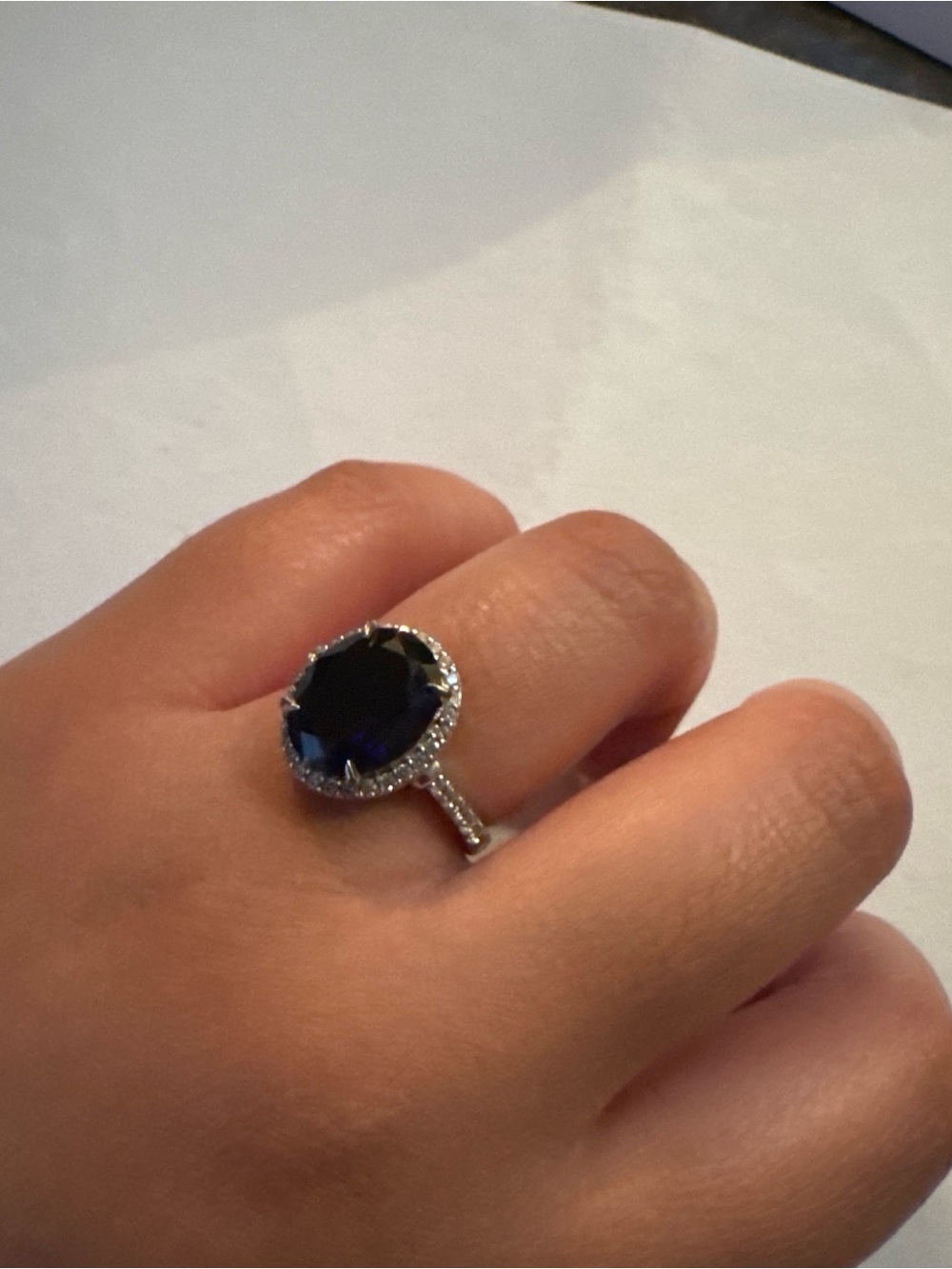 Sterling Silver Ring with Deep Blue Oval Gem and Pavé Halo